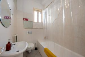 a white bathroom with a sink and a toilet at A Casa Formosa in Porto +25 photos