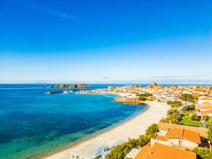 an aerial view of a beach with houses and the ocean at A.I.R. Hotel Gabbiano in Isola Rossa