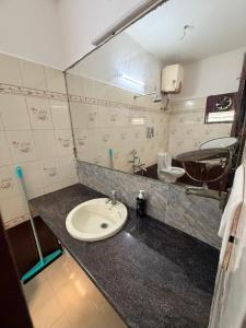 a bathroom with a sink and a mirror at Connect Backpackers Hostel in Chennai +34 photos