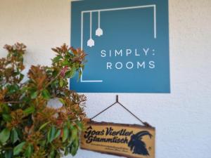 a sign that reads simply rooms hanging on a wall at Simply Rooms in Velden am Wörthersee +14 photos