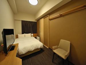 Postel nebo postele na pokoji v ubytování Dormy Inn Akihabara