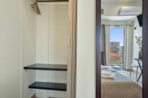a mirror in a room with a bed and a balcony at Motel katerina in Keratea