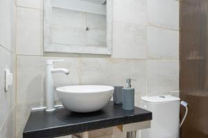 a bathroom with a white bowl sink on a counter at Motel katerina in Keratea