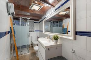a bathroom with a sink and a toilet and a mirror at Casa Palmera - Private Paradise in Tacoronte +27 photos