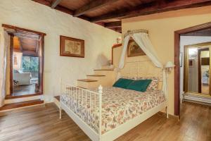 a bedroom with a bed with a canopy at Casa Palmera - Private Paradise in Tacoronte