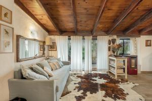 a living room with a couch and some windows at Casa Palmera - Private Paradise in Tacoronte