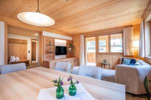 a dining room and living room with a table and chairs at Haus Hoalp in Au