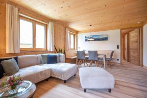 a living room with a couch and a table at Haus Hoalp in Au