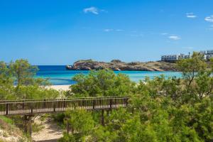 a bridge over a beach with the ocean in the background at Pregonda 13 Menorca in Son Parc