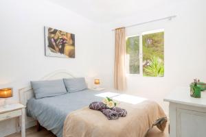 a bedroom with a bed and a window at Pregonda 13 Menorca in Son Parc +26 photos
