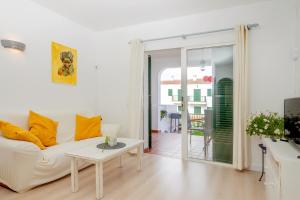 a living room with a white couch and a table at Pregonda 13 Menorca in Son Parc