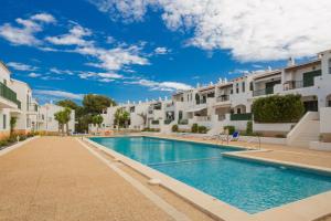 a swimming pool in a villa with white buildings at Pregonda 13 Menorca in Son Parc