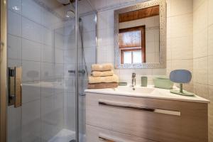 a bathroom with a sink and a shower at Appartement chalet - Le Caribou in Morzine +23 photos