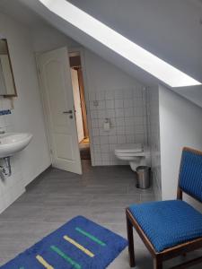 a bathroom with a sink and a toilet and a sink at Ferienwohnung Pieck in Raduhn +8 photos