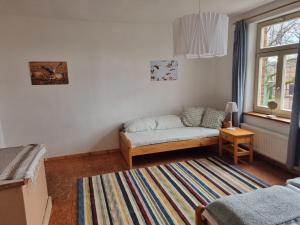 a living room with a couch and a window at Ferienwohnung Pieck in Raduhn