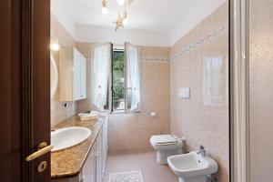 a bathroom with a white toilet and a sink at Bagetti in Varazze +15 photos