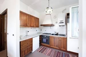 a kitchen with wooden cabinets and a sink at Bagetti in Varazze