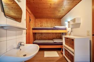 a bathroom with a sink and a bunk bed at Ferienhaus Rommel in Stiefenhofen +11 photos