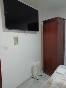 a bedroom with a flat screen tv on the wall at Pensión Veracruz 1 in Granada +96 photos