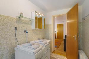 a bathroom with a sink and a mirror at Ferienwohnung Alwine Schulte in Brilon +13 photos