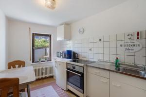 a kitchen with a sink and a stove top oven at Ferienwohnung Alwine Schulte in Brilon