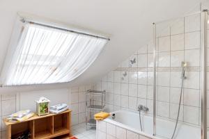 a bathroom with a shower and a tub at Ferienwohnungen Alt in Naumburg +41 photos