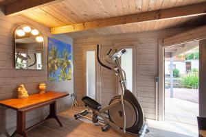 a room with a desk and a treadmill and a table at Fewo Standfuss in Dausenau