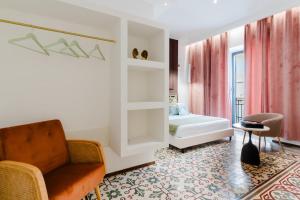 a bedroom with a bed and a chair and a table at Le Sanpietrane in Taviano
