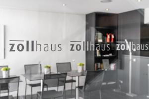 a dining room with tables and chairs and a sign at Zollhaus - Doppelzimmer in Endingen +8 photos