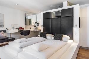 a large white bed in a room with a desk at Zollhaus - Doppelzimmer in Endingen
