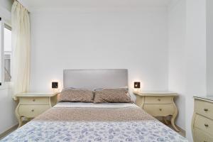 a bedroom with a bed with two night stands at Apartamento Lola 2 in Nerja