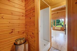 a log cabin with a trash can in a hallway at Ferienhaus 'Albblick' in Starzach +21 photos