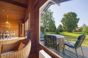 a screened in porch with a table and chairs at Ferienhaus 'Albblick' in Starzach