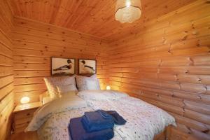 a bedroom with a bed in a wooden cabin at Ferienhaus 'Albblick' in Starzach