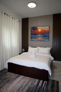 a bedroom with a large bed with white sheets at Villa Di Angelo Negombo in Negombo +52 photos