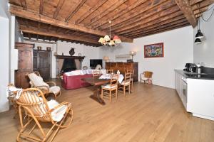a kitchen and living room with a table and chairs at La maison Bayle in Mauvezin