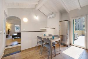 a kitchen and dining room with a table and a refrigerator at Ca di Perti Apt 3 in Finale Ligure