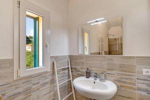 a bathroom with a sink and a mirror at Ca di Perti Apt 3 in Finale Ligure +21 photos