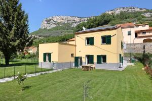 a house with a picnic table in a yard at Ca di Perti Apt 3 in Finale Ligure