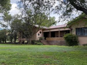 a house with a grass yard in front of it at Venterspoort Farmhouse in Philipstown