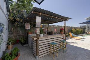 a bar in a backyard with a wooden pergola at Casa Encarnacion in Granada