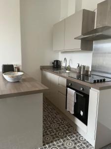 a kitchen with a sink and a stove top oven at 1 Bed Flat in Weston-super-Mare