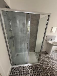 a glass shower in a bathroom with a sink at 1 Bed Flat in Weston-super-Mare +14 photos