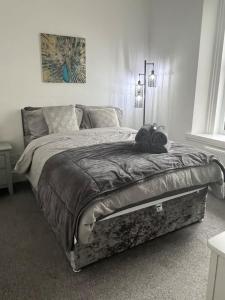 a bedroom with a large bed with a blanket at 1 Bed Flat in Weston-super-Mare