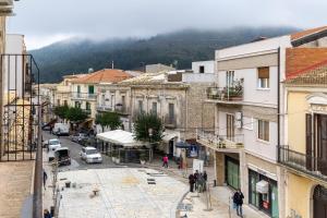 a group of people walking down a city street at Pollicita 80 in Chiaramonte Gulfi