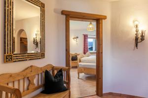 a bedroom with a mirror and a bed in a room at Panorama Lodge Leutasch mit Sauna in Leutasch
