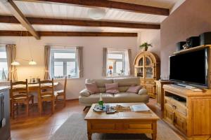 a living room with a couch and a table at Fewo Nordermühle in Pellworm