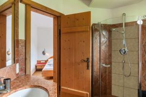 a bathroom with a shower and a sink and a mirror at Panorama Lodge Leutasch mit Sauna in Leutasch +39 photos