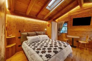 a bedroom with a bed in a wooden room at Antirouille Casa Vacanze in Aymavilles +20 photos