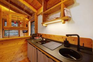 a kitchen with a sink in a cabin at Antirouille Casa Vacanze in Aymavilles